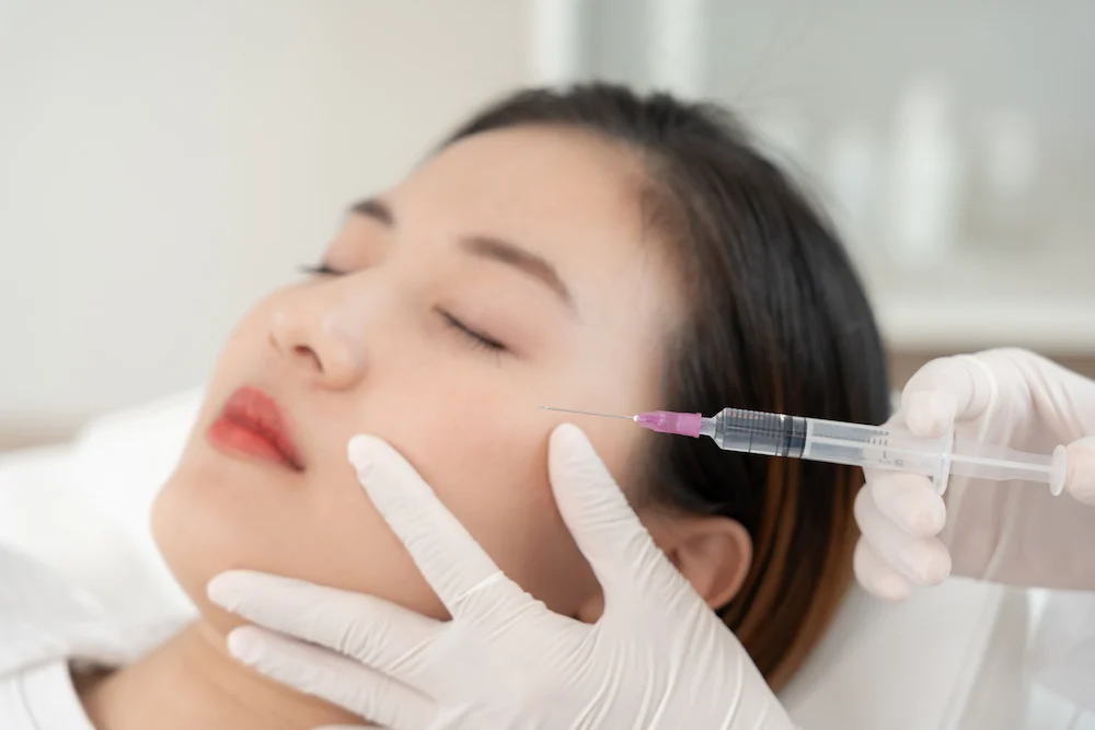 A therapist are injected the girl who are doing masseter-V lift at SR clinic.